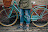 Person in Brown Jacket Standing Beside Bicycle