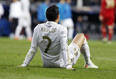 Cristiano Ronaldo sat on the grass after the defeat against Bayern