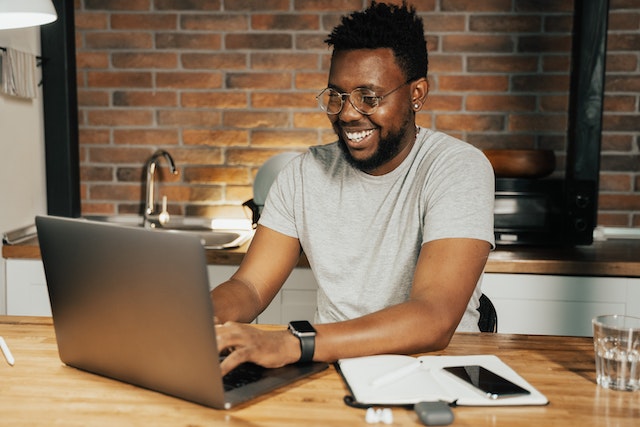 Man sitting at a desk and researching how to create a virtual tour that sells your home