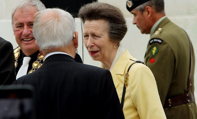 Princess Anne wore a yellow wool jacket and floral print midi dress. The Princess wore a grey trench coat by Musto, and floral dress