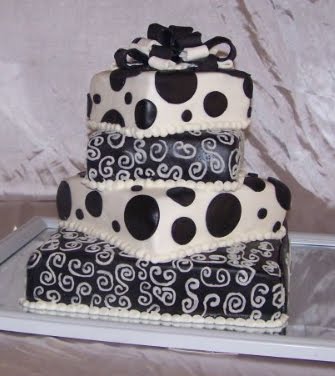 Modern square wedding cake in black and white with black dots on white icing