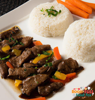 Image of cooked beef strips served with steamed rice and veggies
