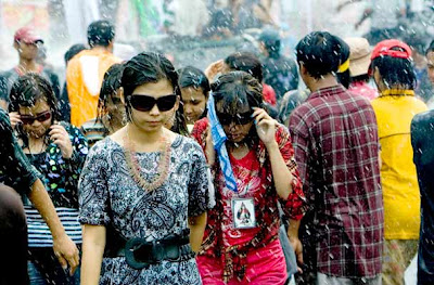 Young people are sprayed with water during the annual â€˜water festivalâ€™ in Yangon, Myanmar 