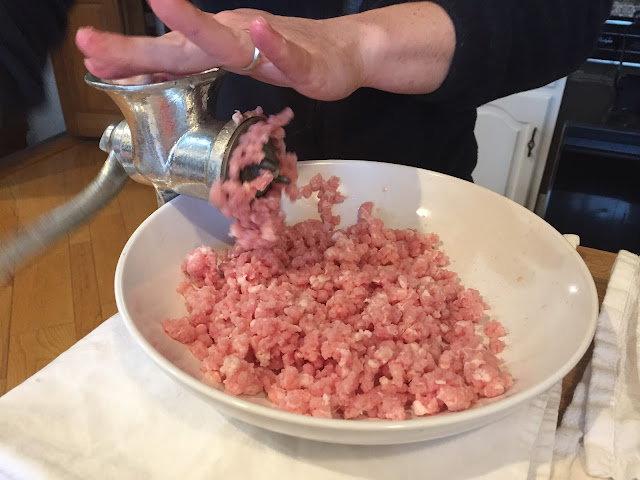 Hand-grinding boneless pork chops for making larb