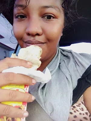 ' Shachem Lieuw eating a roti roll lever ( roti roll chicken liver) from Jairoop roti shop Ringweg Suriname"