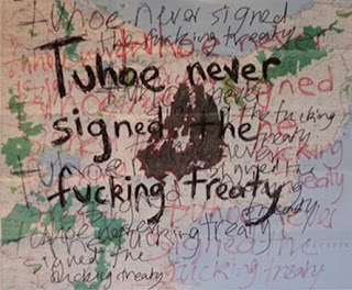 An art work - tuhoe never signed the fucking treaty is repeatedly scribbled in different colours on a map of New Zealand