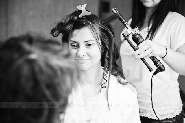 The bride looking at her mother while preparing for her wedding