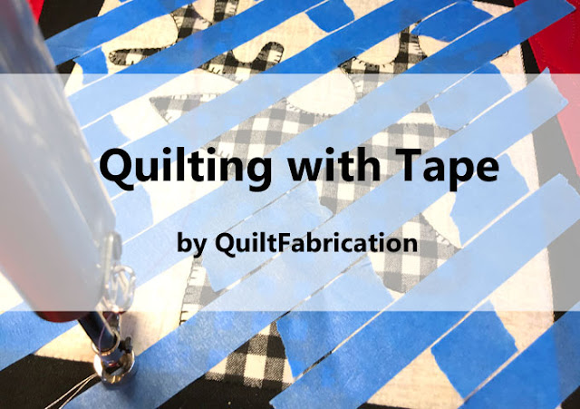 applique quilt block with blue painters tape to mark straight lines for quilting