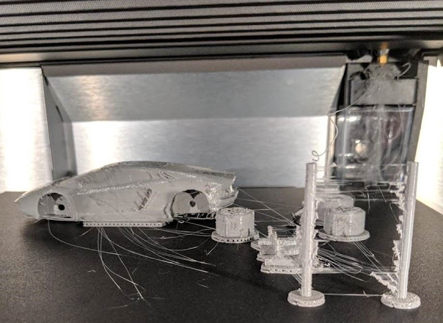 3D printed model car inside 3D printer.