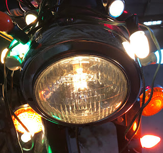 Royal Enfield headlight with Christmas lights.