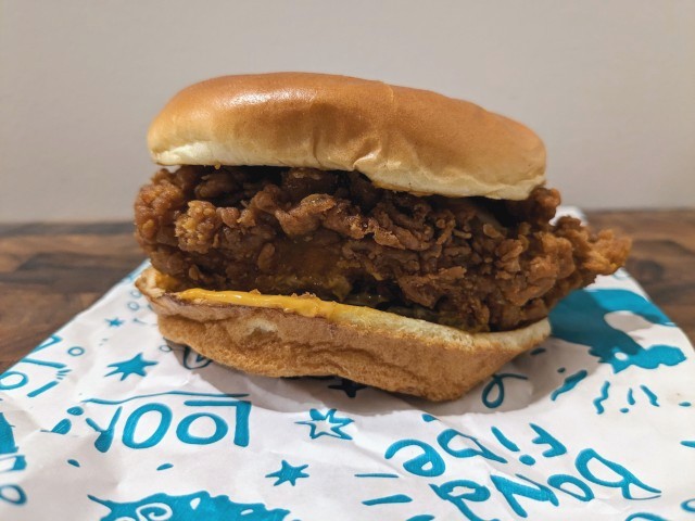 Side view of Popeyes Spicy Truff Chicken Sandwich.