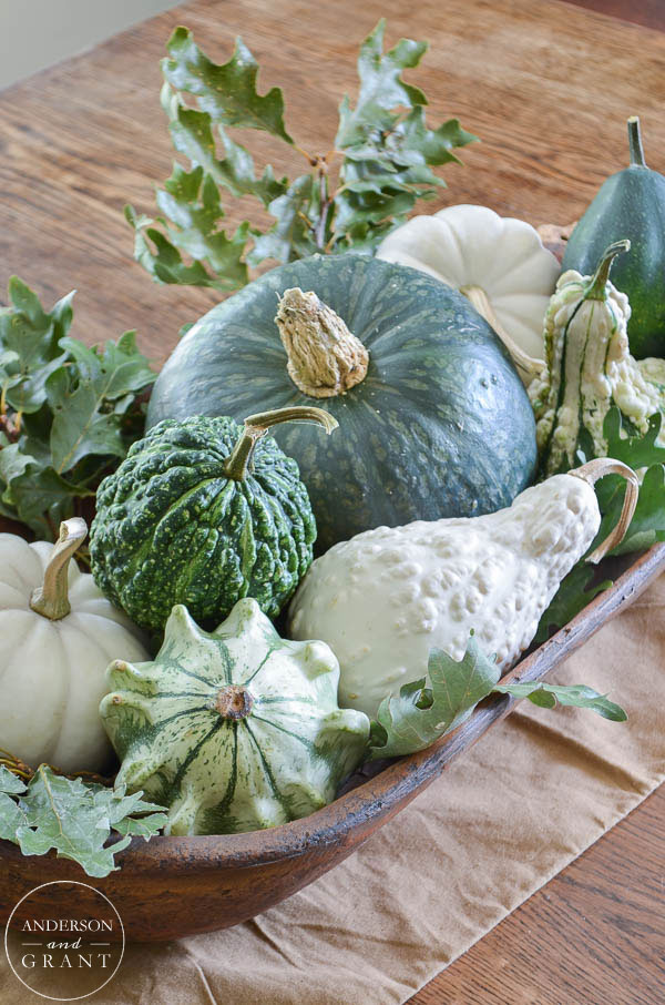 Isn't this dough bowl filled with fall squash, gourds, and pumpkins beautiful for the dining room table?  |  www.andersonandgrant.com