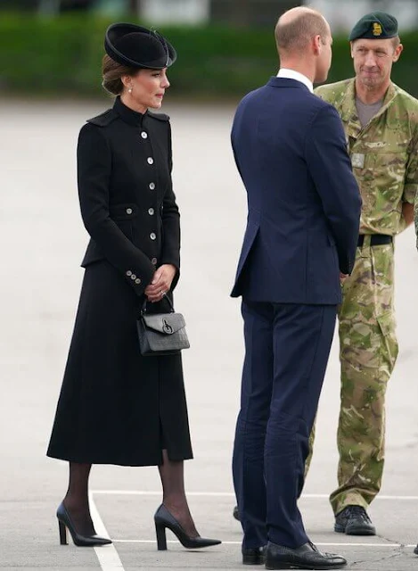 Kate Middleton wore a sharp black coat layered over a sleek black dress by Alexander McQueen. Mulberry handbag