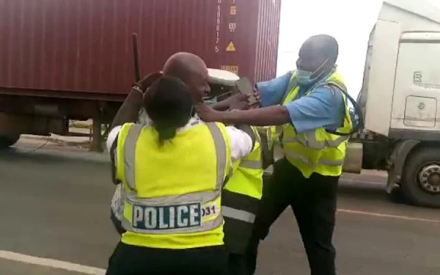 Police entering a car through a window  and fighting