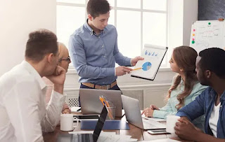 A man confidently presents to a group, showcasing his leadership potential.