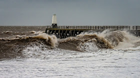 Photo of big waves rolling in at the start of the storm
