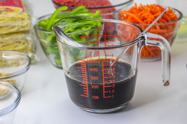 homemade sauce in a clear measuring cup.