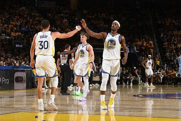 Stephen Curry (#30) and Jimmy Butler (#10) of the Golden State Warriors high-five during the game against the Memphis Grizzlies in the 2025 SoFi Play-In Tournament at Chase Center in San Francisco, California, on April 15, 2025. Photo by Noah Graham/NBAE