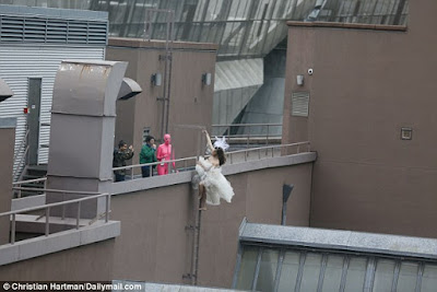 Bride, Her Wedding Gown And Her Unlikely Partner Seen Climbing Up A Rooftop In New York.