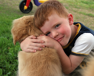 Child hugging dog