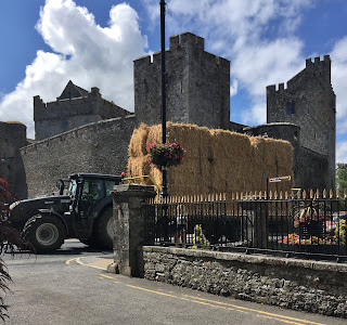 A farmer drives by Cahir Castle in Cahir, Tipperary,  Ireland