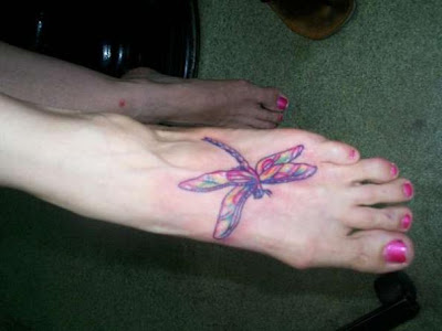 Rainbow dragonfly tattoo on foot.
