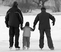 A family out ice skating in winter.