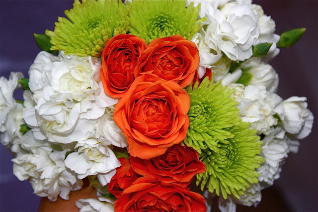 My homemade grocery-store bridal bouquet, made with baby white carnations, orange tea roses, and chartreuse baby mums