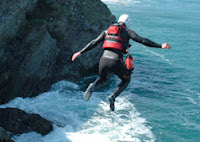 A Man Jumping Off a Cliff whilst Coasteering
