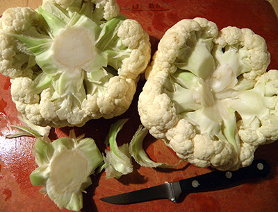 2 Cauliflowers on Cutting Board with one Core Removed