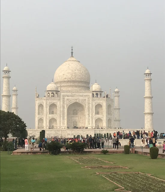 Full view of Taj Mahal monument with crowd of visitors around, Agra, India.