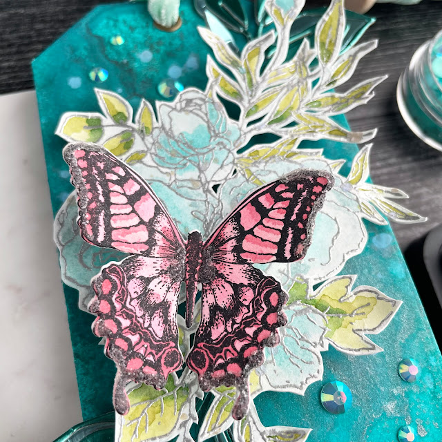 Mica Tag Trio created with: Tim Holtz distress inks, distress spray stain, distress oxide sprays, mica sprays, floral outlines stamp set, flutter butterly stamp and die set, velvet trim, metallic kraftstock, bloom colorize die; Pinkfresh jewels