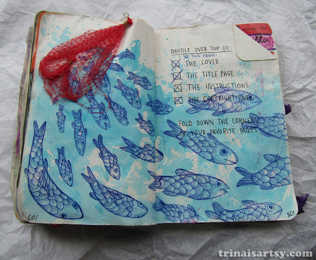 Wreck this Journal -  Doodle over top of this page featuring blue fish escaping from a net