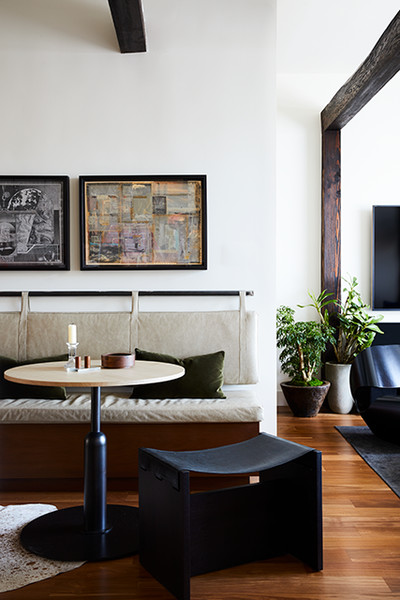 banquette bench with pad hung on wall and round breakfast table