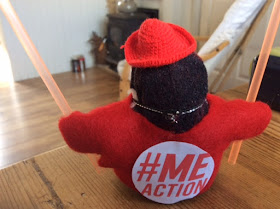 MEme a small stuffed penguin which is Corina Duyn's alter ego, is ready for action for M.E.  wearing a red tshirt with the Action for ME logo 