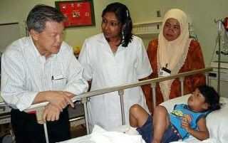 Dr Chua visiting three-year-old Juliana Anak Hairy at the Cameron Highlands Hospital on Monday as medical student S. Gaitri (centre) and hospital director Dr Mahanim Md Yusof look on.