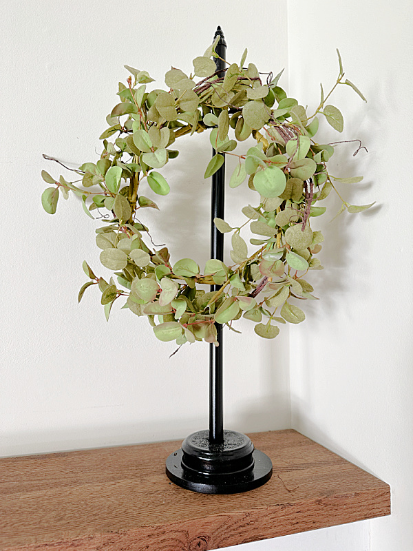 olive wreath on wreath stand