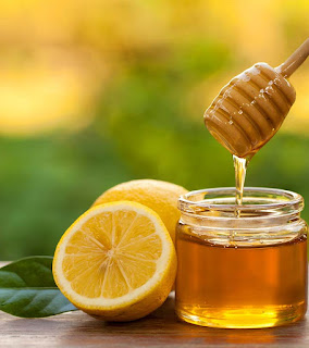 a sliced ​​lemon and honey in a jar