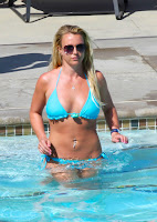 Britney Spears wearing a blue bikini and goes for a dip in a the pool