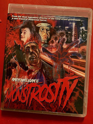 A blu-ray cover full of bloody chaotic images, with text that reads,  From the most legendary director of the 42nd street grindhouse a new breed of Hollywood horror.   Andy Milligan’s Monstrosity