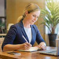 woman sitting and writing