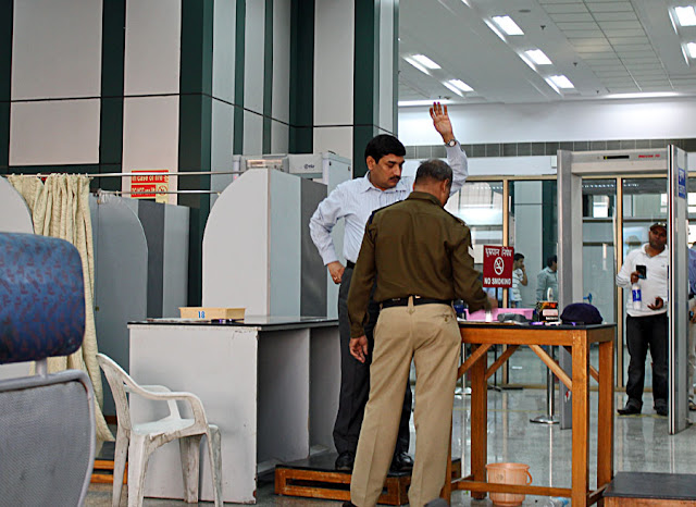 man being checked by airport security