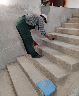Bekir sweeping before joining in the plastering