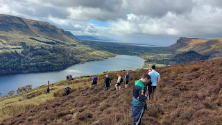 Walkers on Glencar Escarpment with lake view below