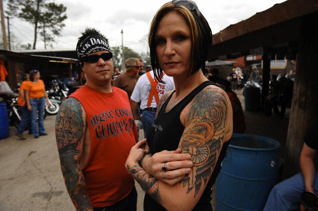 A female with yellow dragon tattoo on her arm.