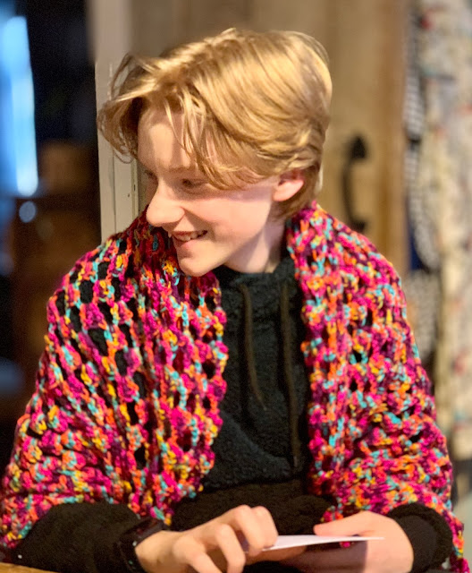 teen with crochet blanket round shoulders