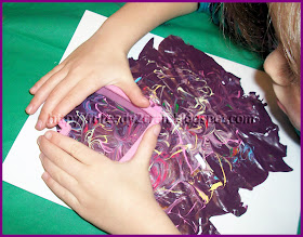 Creating shapes out of the paint skin for Valentine's Day Craft