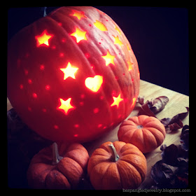 Halloween pumpkin carved with cookie cutters, stars and hearts shape