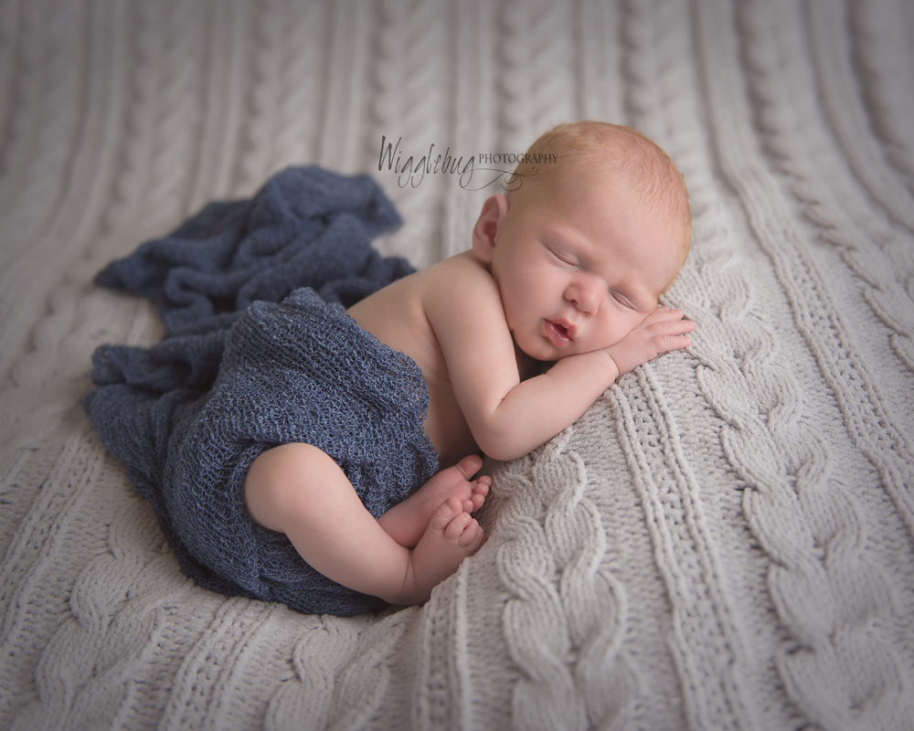 Perfect newborn baby boy in blue and gray