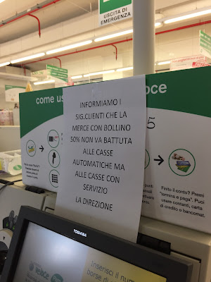 Sign asking customers to not use the automatic check-out for items discounted 50%.